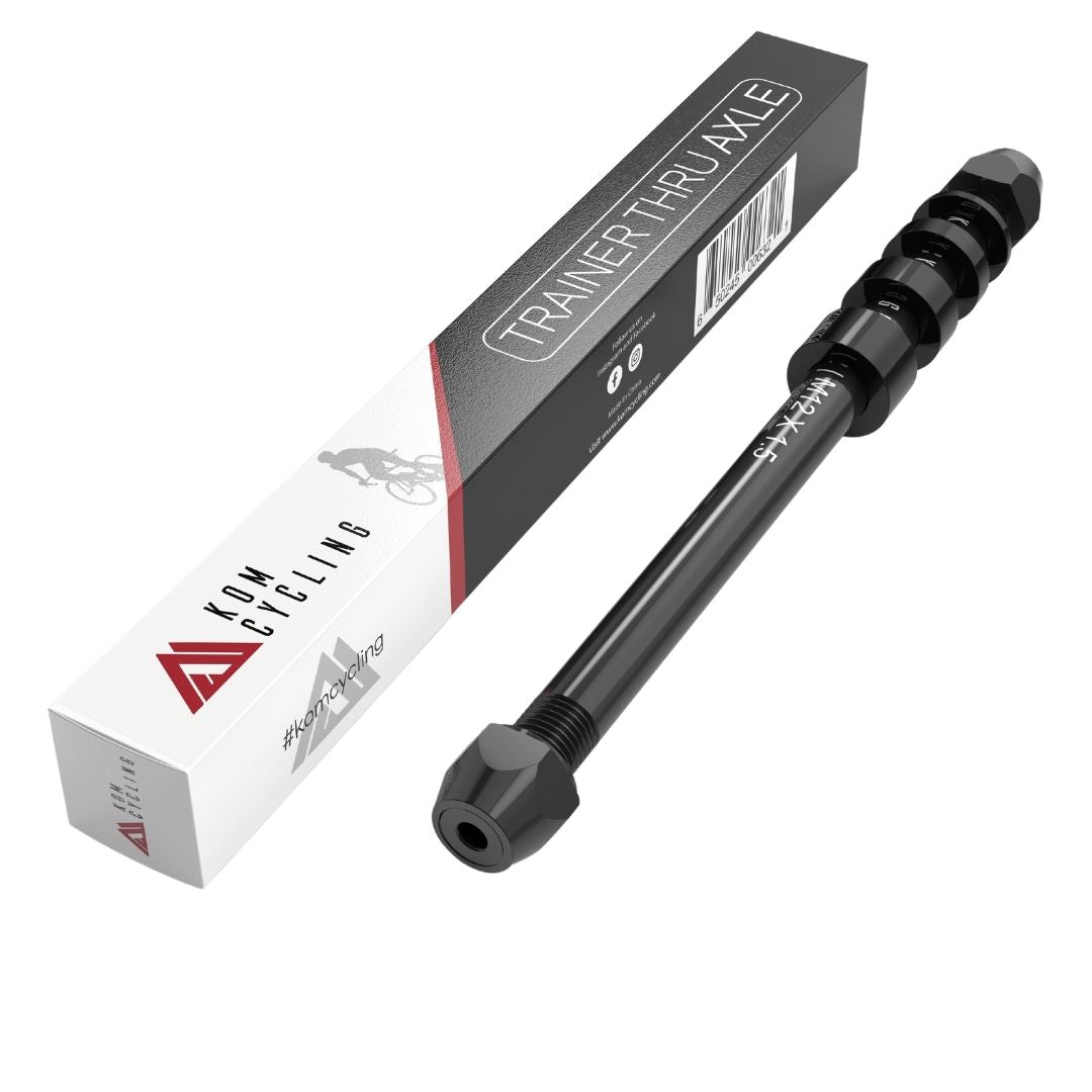 KOM universal thru axle in black with its ribbed handle, beside the retail box