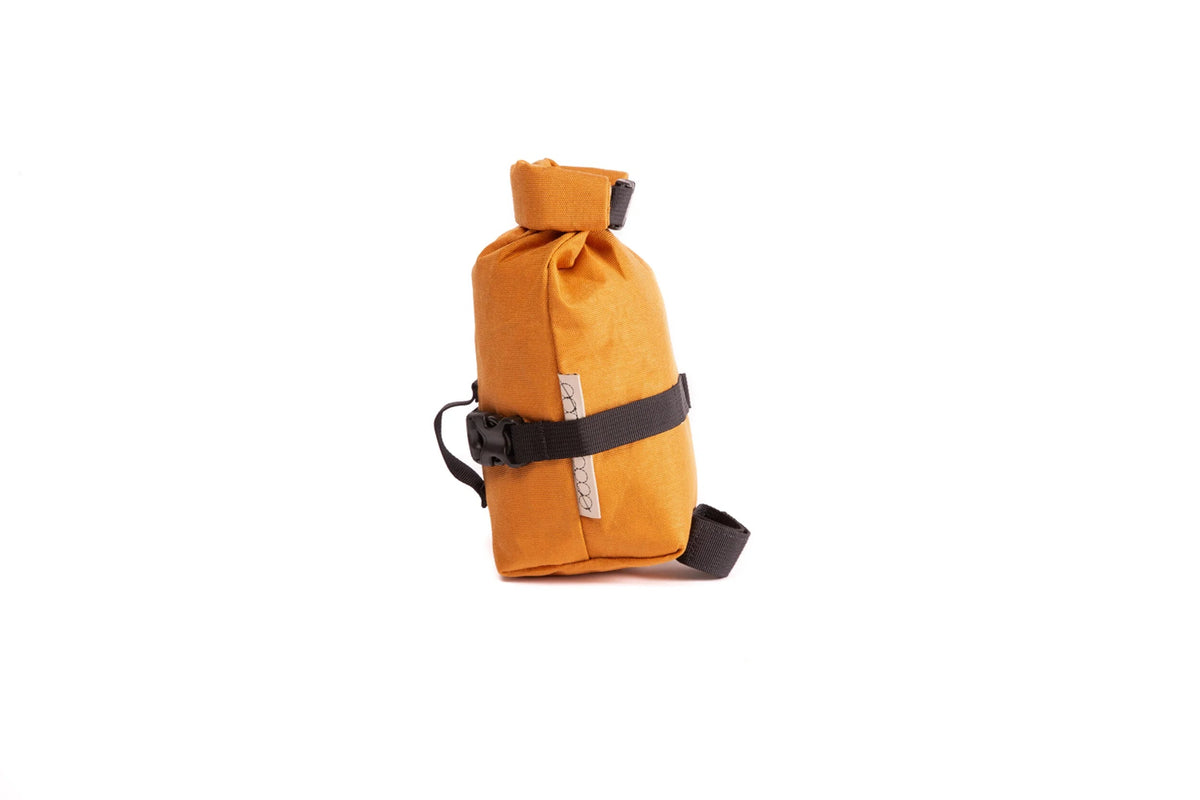 Outer Shell Rolltop Saddlebag, orange, side view with strap