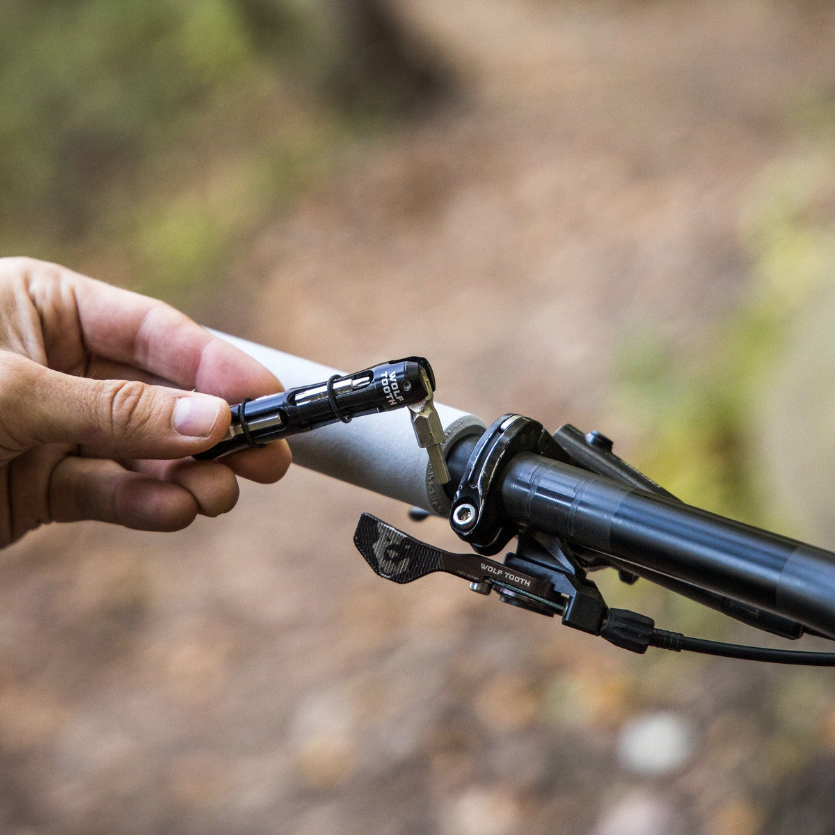 Wolf Tooth EnCase System Bar Kit One, tightening a stem bolt on the trail