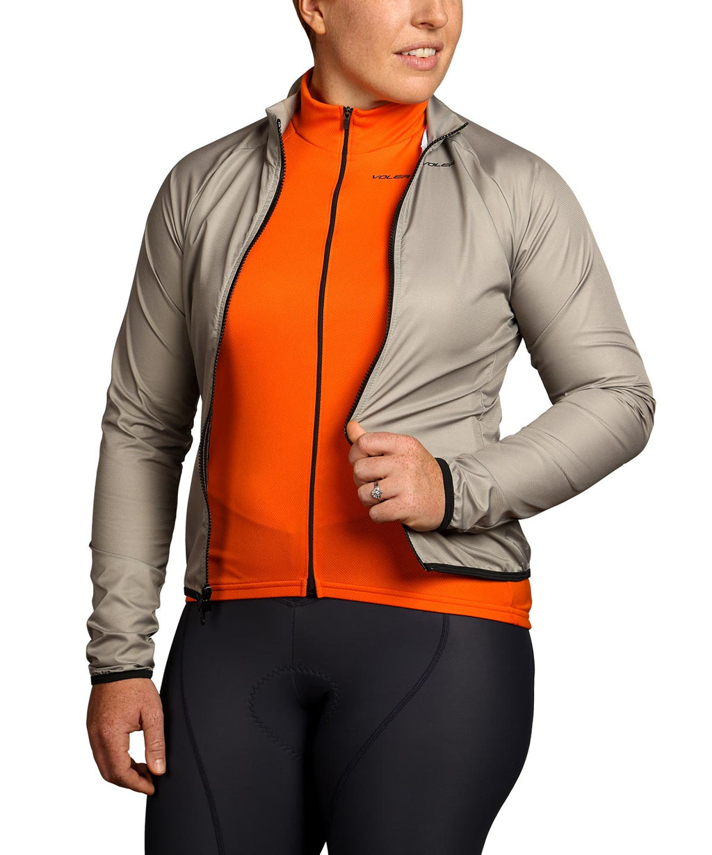 Voler Women's Jet Lightweight Long Sleeve Jersey, orange, worn under an open wind jacket