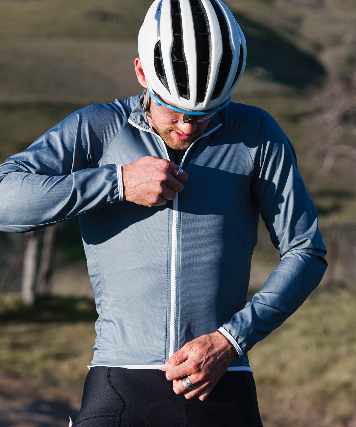 Voler Men's Wind Jacket, Iron, rider zipping the jacket