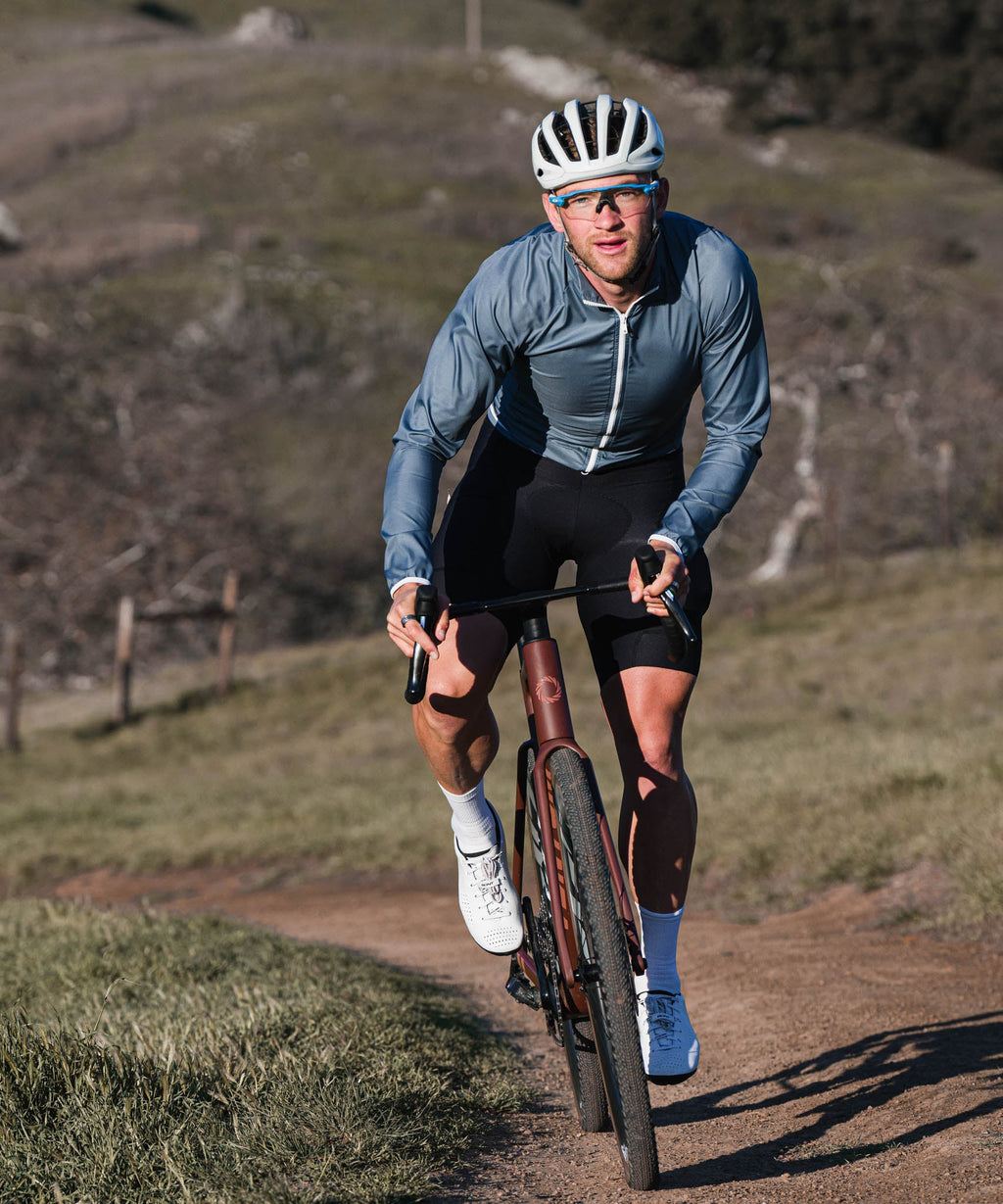 Voler Men's Wind Jacket, Iron, worn riding a gravel trail, front view