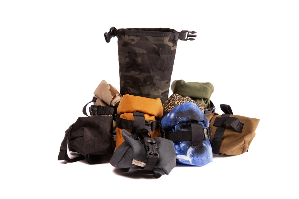 Outer Shell Rolltop Saddlebag, pile of bags in several colors