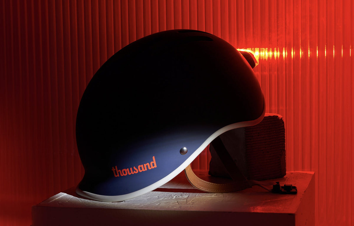 Magnetic Helmet Light, lit red on the back of a navy helmet