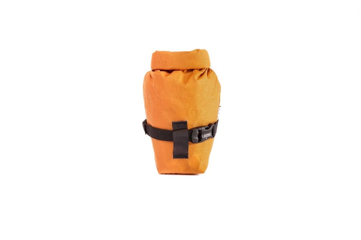 Outer Shell Rolltop Saddlebag, orange, front view with strap