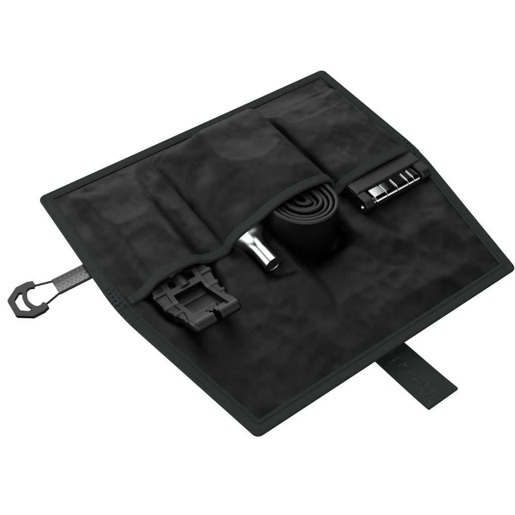 KOM Saddle Roll, unrolled with a tube and tools in the pockets, angled view