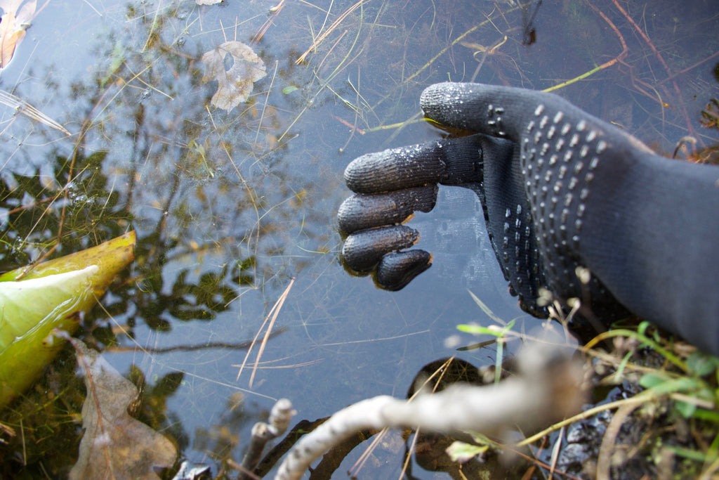 Cross Point Waterproof Knit Gloves: Sport, worn on a hand reaching toward water