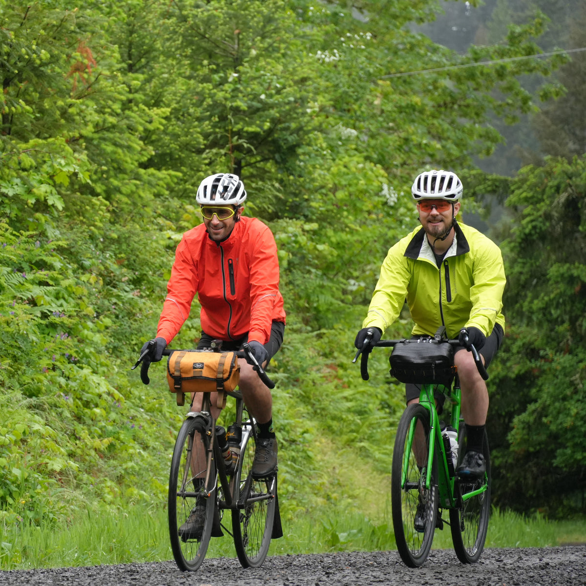 Men's Century Jacket, orange and hi-vis yellow, two riders on a gravel road