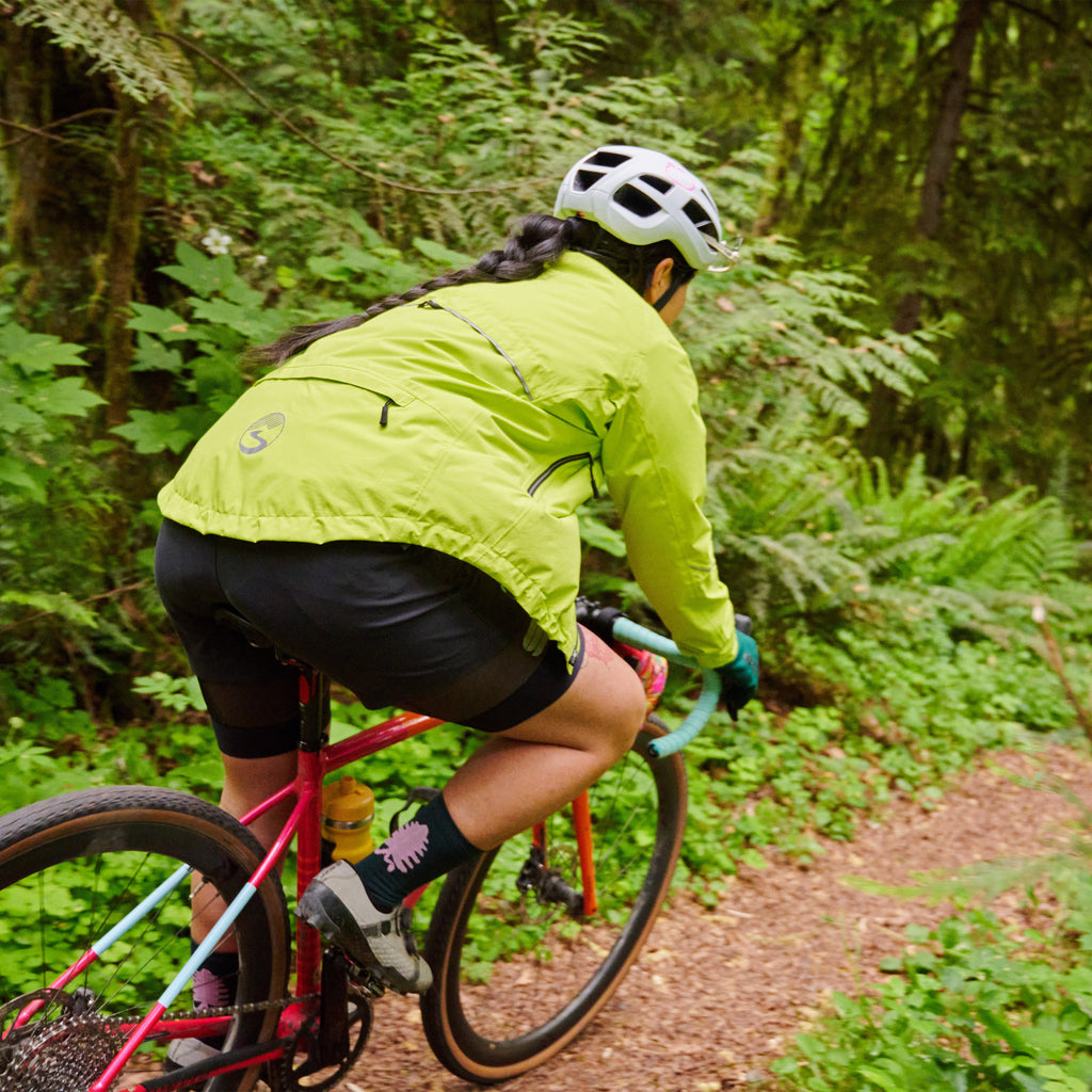Women's Century Jacket, hi-vis yellow, riding a forest trail, seen from behind