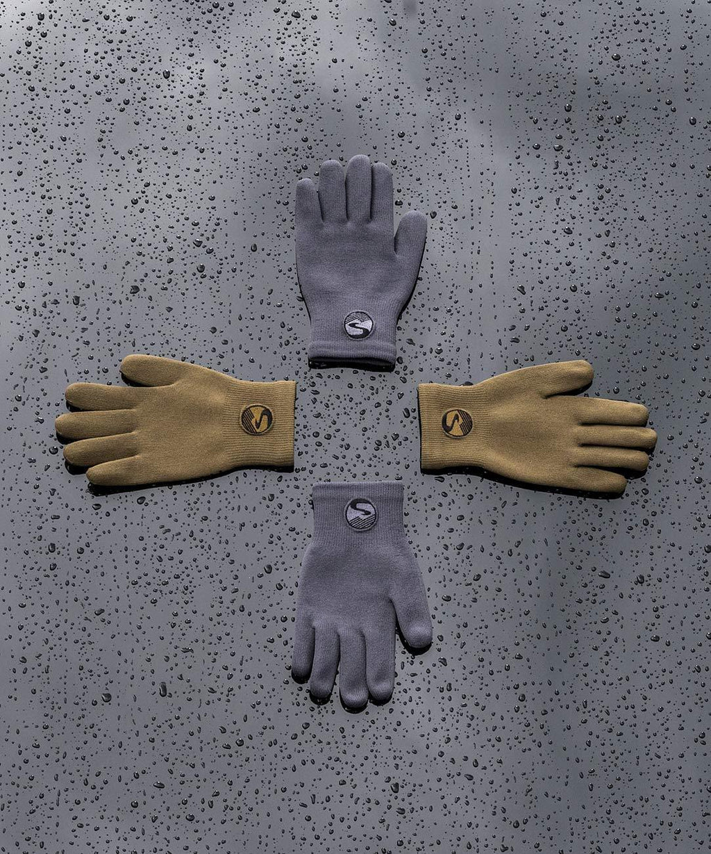 Cross Point Waterproof Knit Gloves: Pro Wool, gray and tan gloves laid out on a wet surface