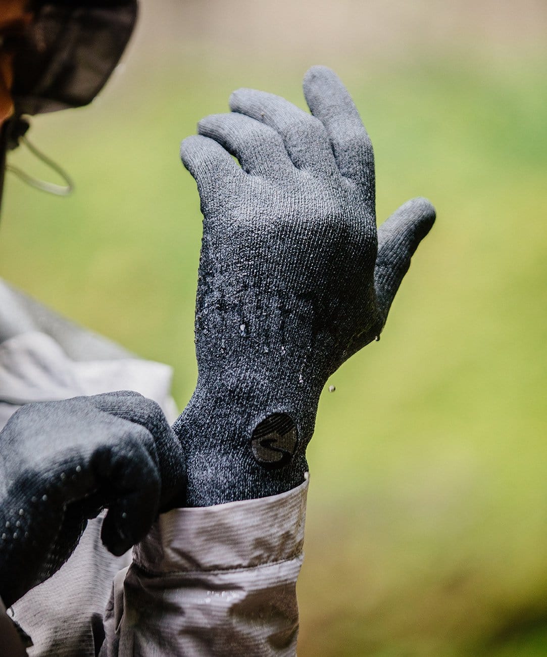 Cross Point Waterproof Knit Gloves: Pro Wool, gray, wet, pulled on over a jacket cuff