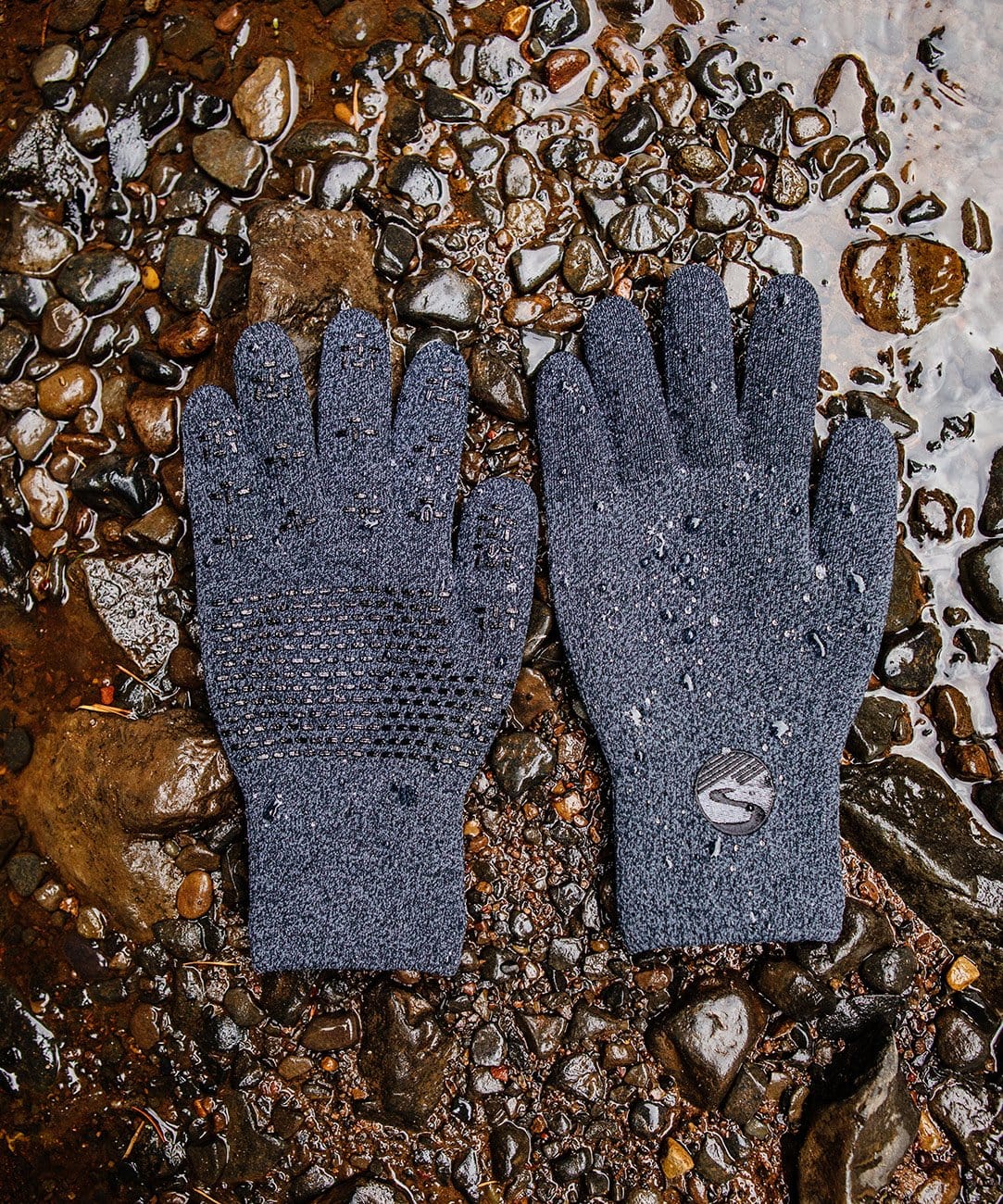 Cross Point Waterproof Knit Gloves: Pro Wool, gray pair laid on wet gravel