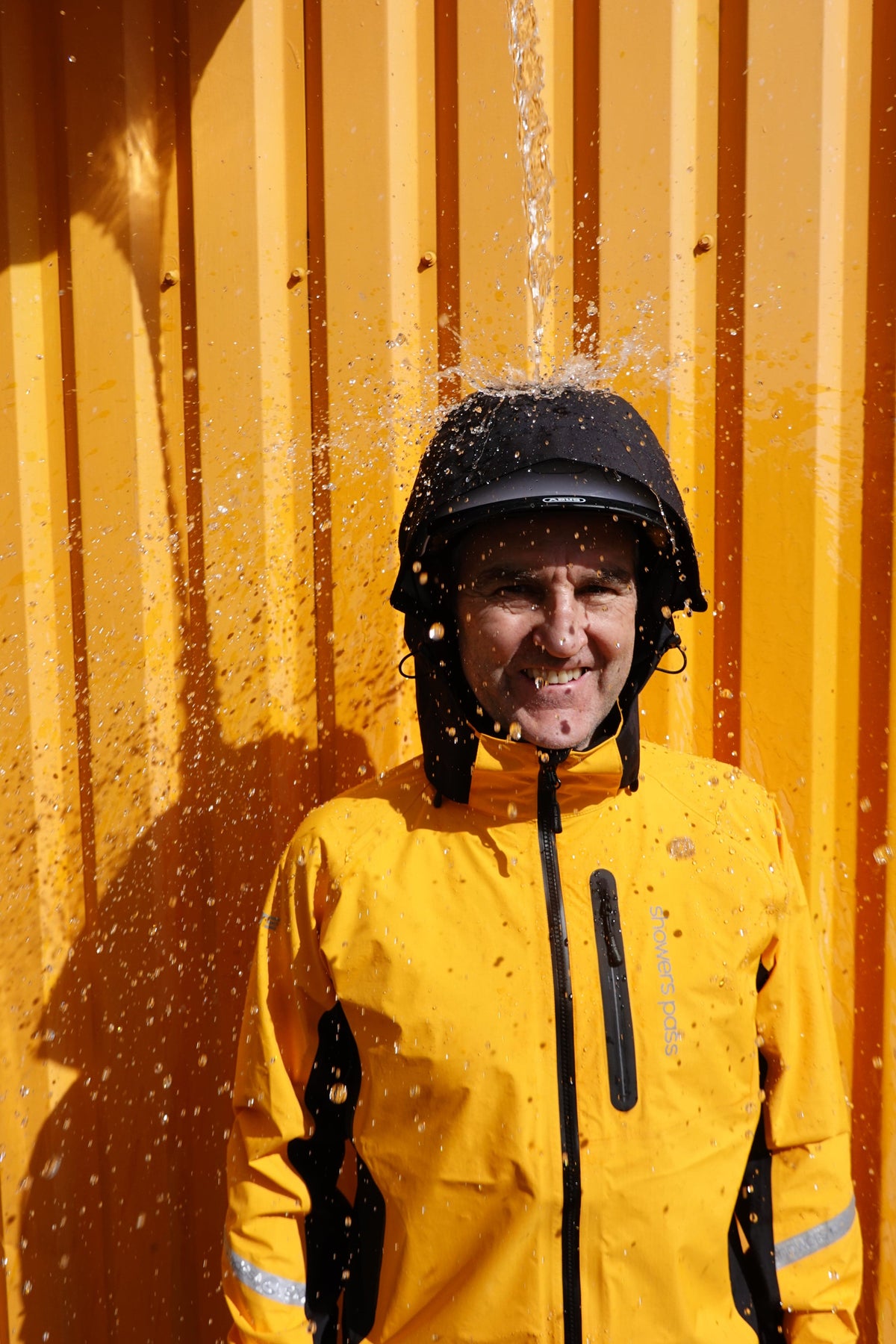 Waterproof Rain Hood - Gen III, worn with a yellow rain jacket in the rain
