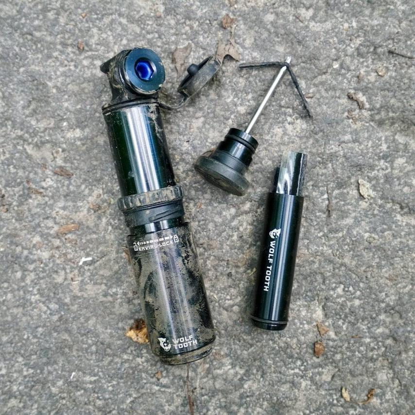 Wolf Tooth EnCase Pump 40cc, pump taken apart with the stored tools on the ground