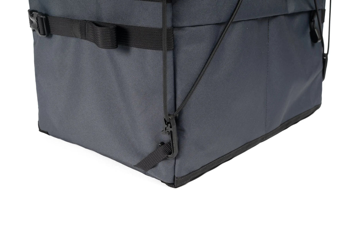 Outer Shell Rack Bag, close-up of the bottom corner and bungee
