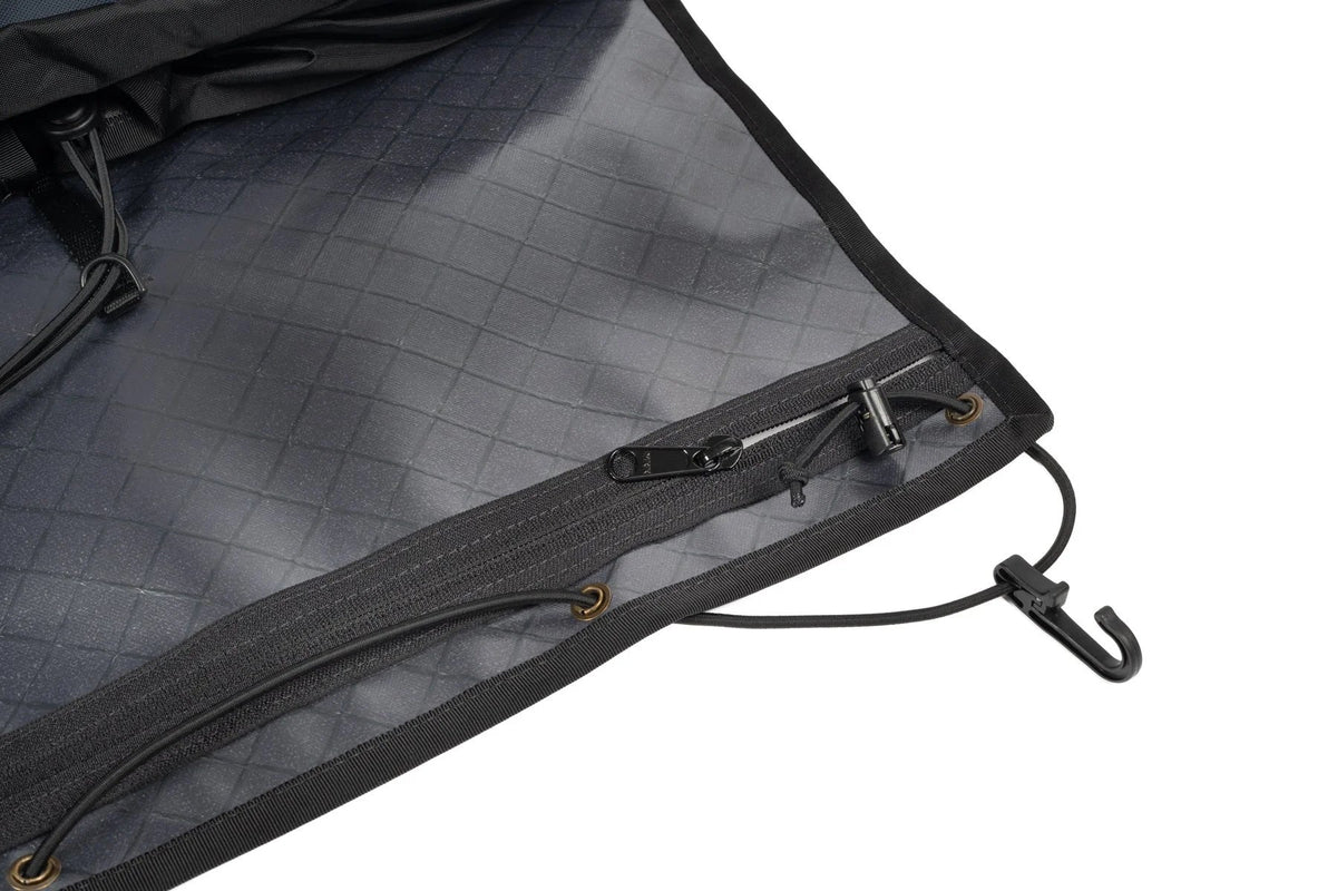 Outer Shell Rack Bag, close-up of the flap and bungee hook