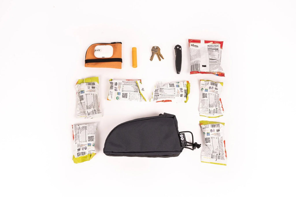 Outer Shell Top Tube Bag, laid out with the snacks and tools it holds