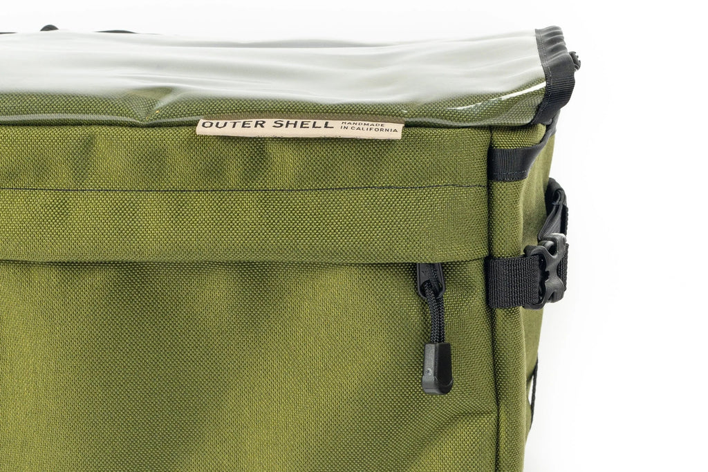Outer Shell 137 Basket Bag, close-up of the front label and flap