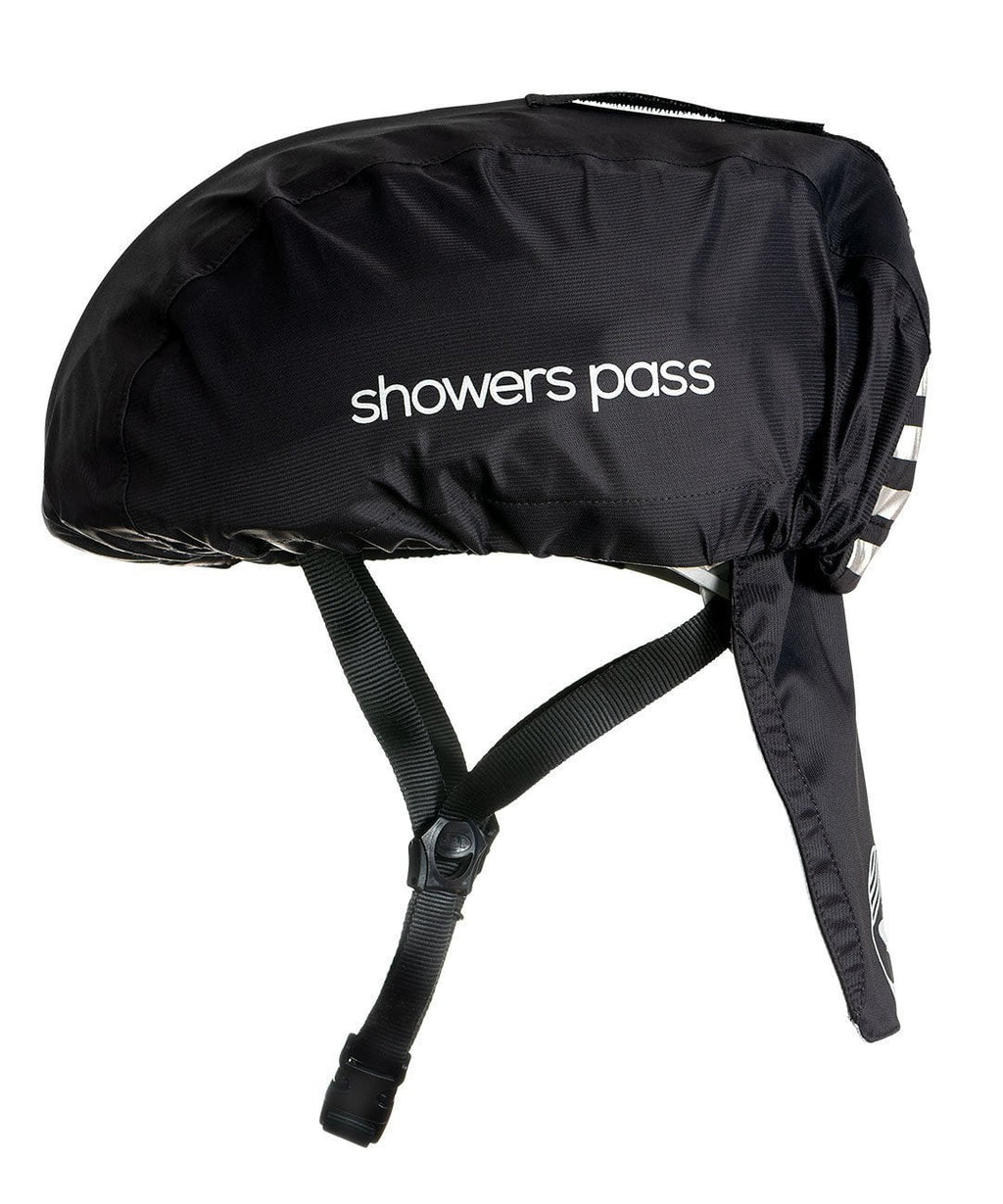 Showers Pass helmet cover in black pulled over a bike helmet, side view, wordmark across the side and the drop-down rear tail in place.