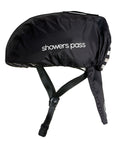 Showers Pass helmet cover in black pulled over a bike helmet, side view, wordmark across the side and the drop-down rear tail in place.