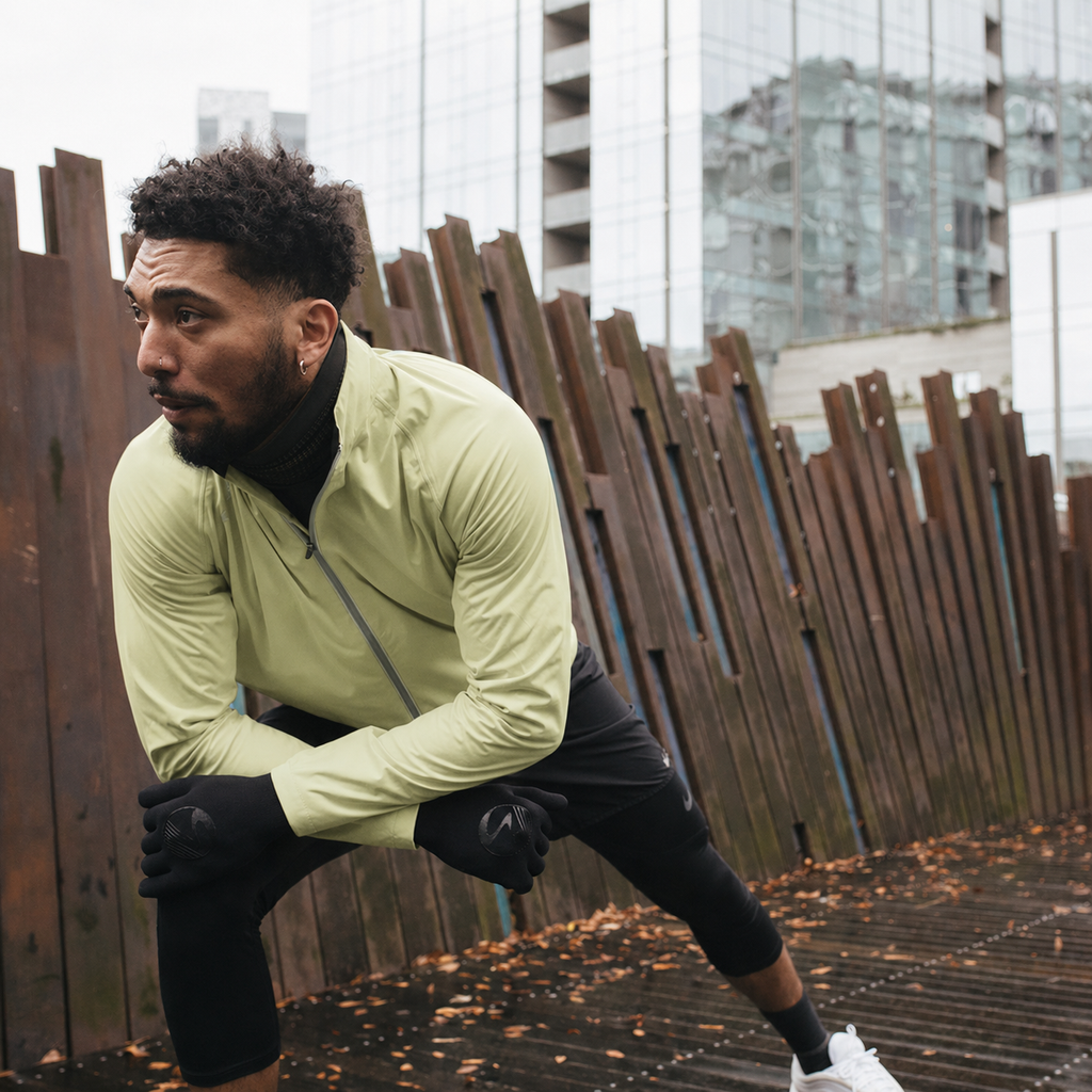 Men's Cloudburst Jacket, light green, worn while stretching before a run