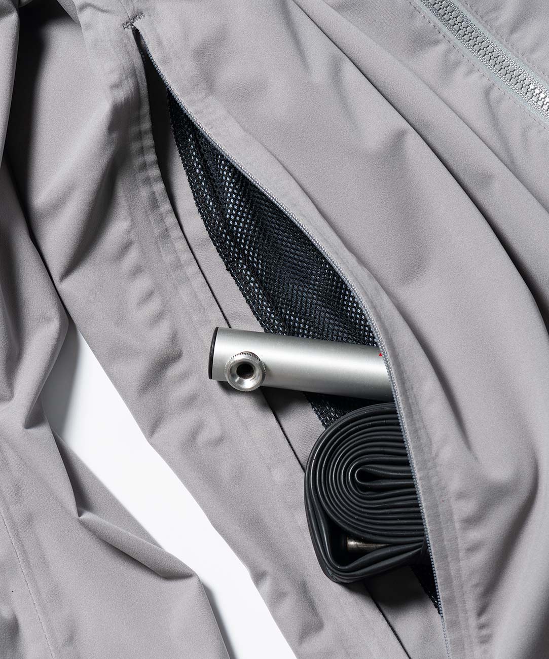 Men's Cloudburst Jacket, close-up of the back pocket holding a tube and CO2