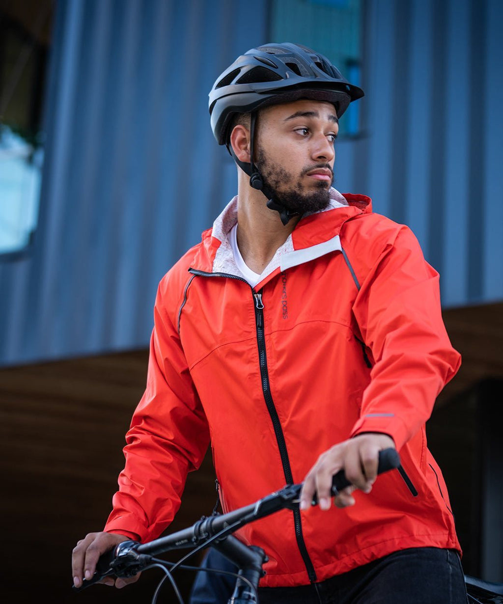 Men's Syncline CC Jacket, orange, worn by a rider with a helmet at the handlebars