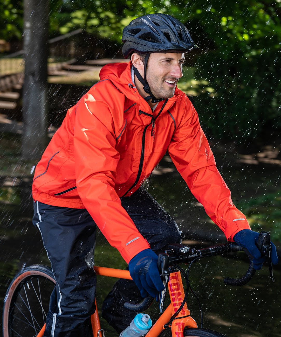 Men's Syncline CC Jacket, orange, worn by a rider on a bike