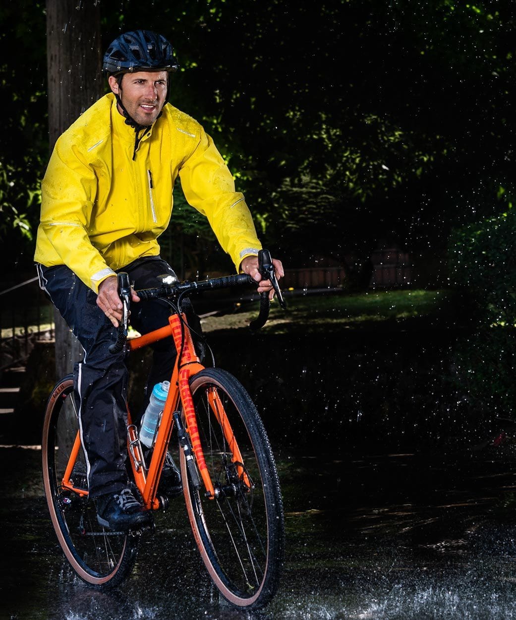 Men's Transit Pant, worn riding in the rain with a yellow jacket