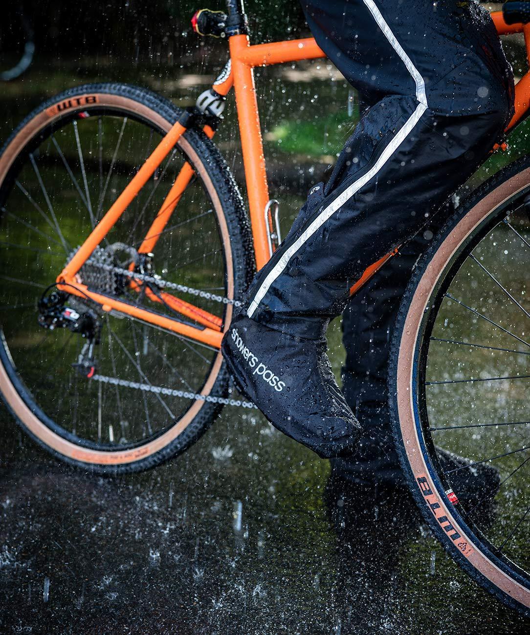 Men's Transit Pant, worn riding through rain, close-up of the lower leg
