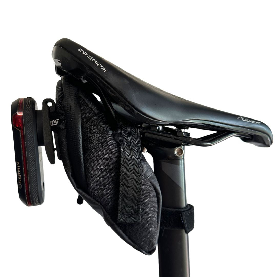 KOM Saddle Bag Radar Mount for Garmin Varia, clipped to a saddle bag with a radar tail light