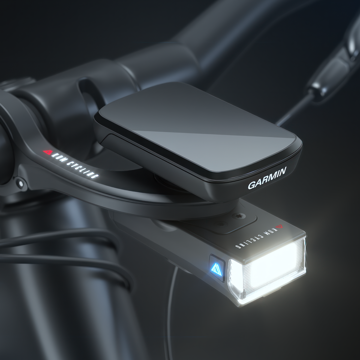 KOM Quick Release Light, 350 Lumen, mounted under a bike computer on the handlebar, light on