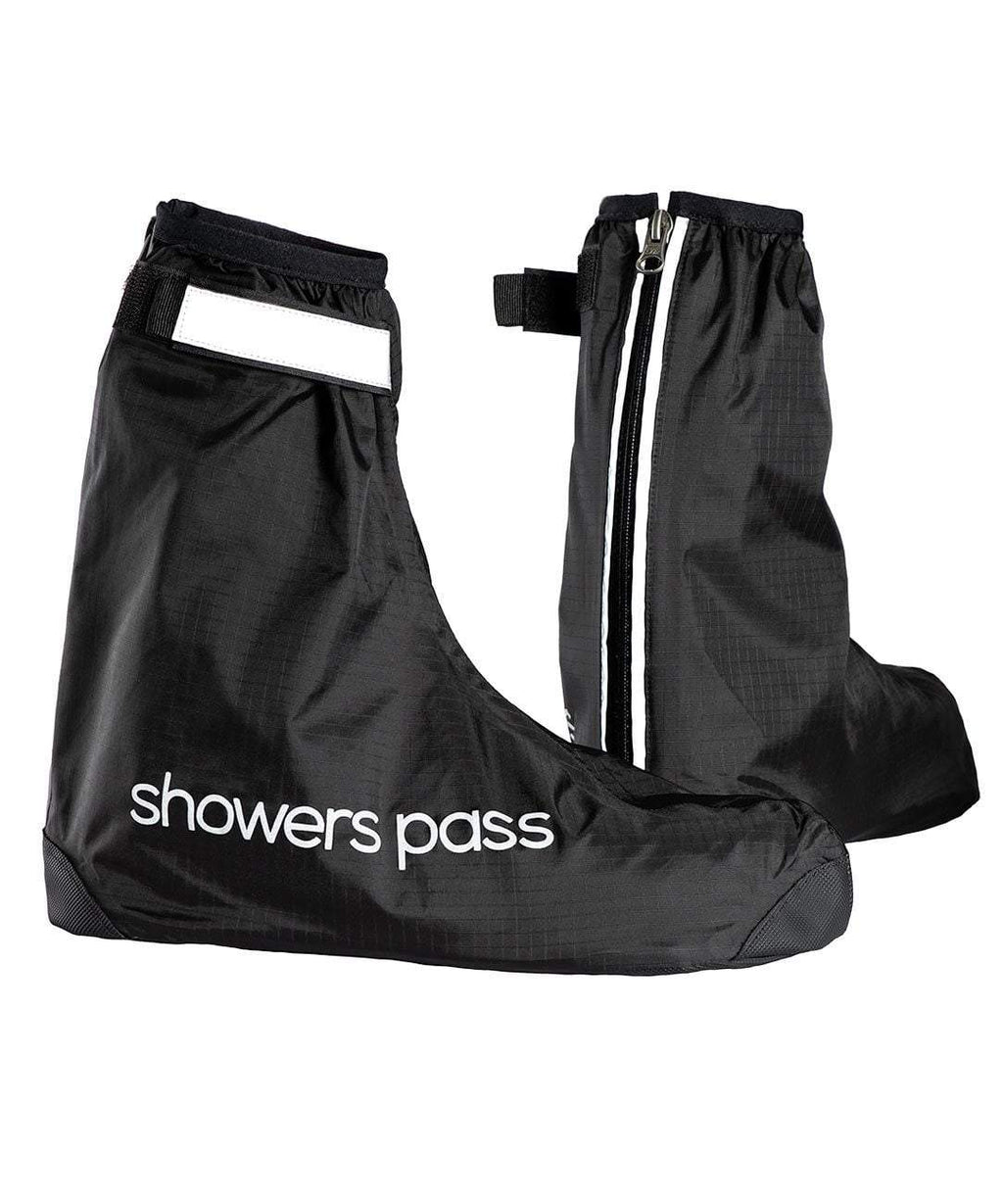 Pair of black Showers Pass Club waterproof shoe covers, one side on with the wordmark, the other from behind showing the reflective rear zip and tab.