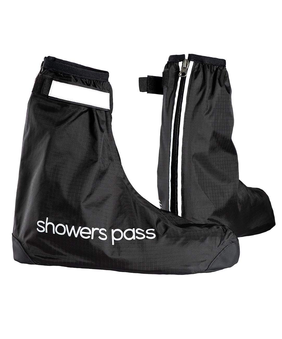 Pair of black Showers Pass Club waterproof shoe covers, one side on with the wordmark, the other from behind showing the reflective rear zip and tab.