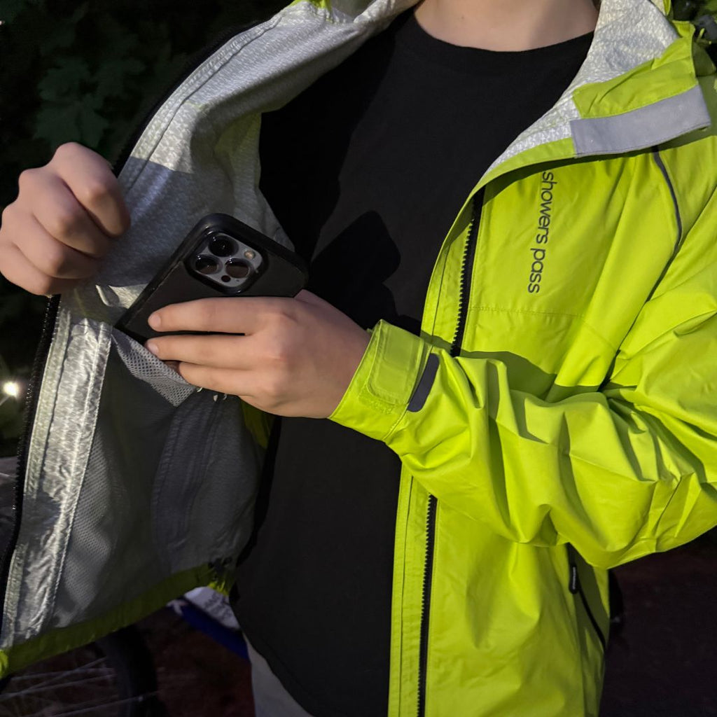 Men's Syncline CC Jacket, hi-vis yellow, phone going into the inside pocket