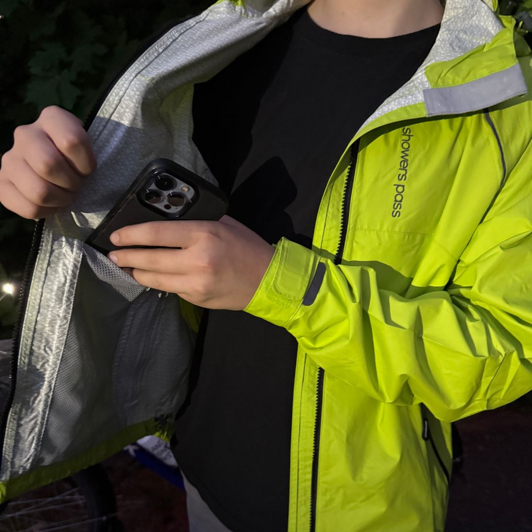 Men's Syncline CC Jacket, hi-vis yellow, phone going into the inside pocket