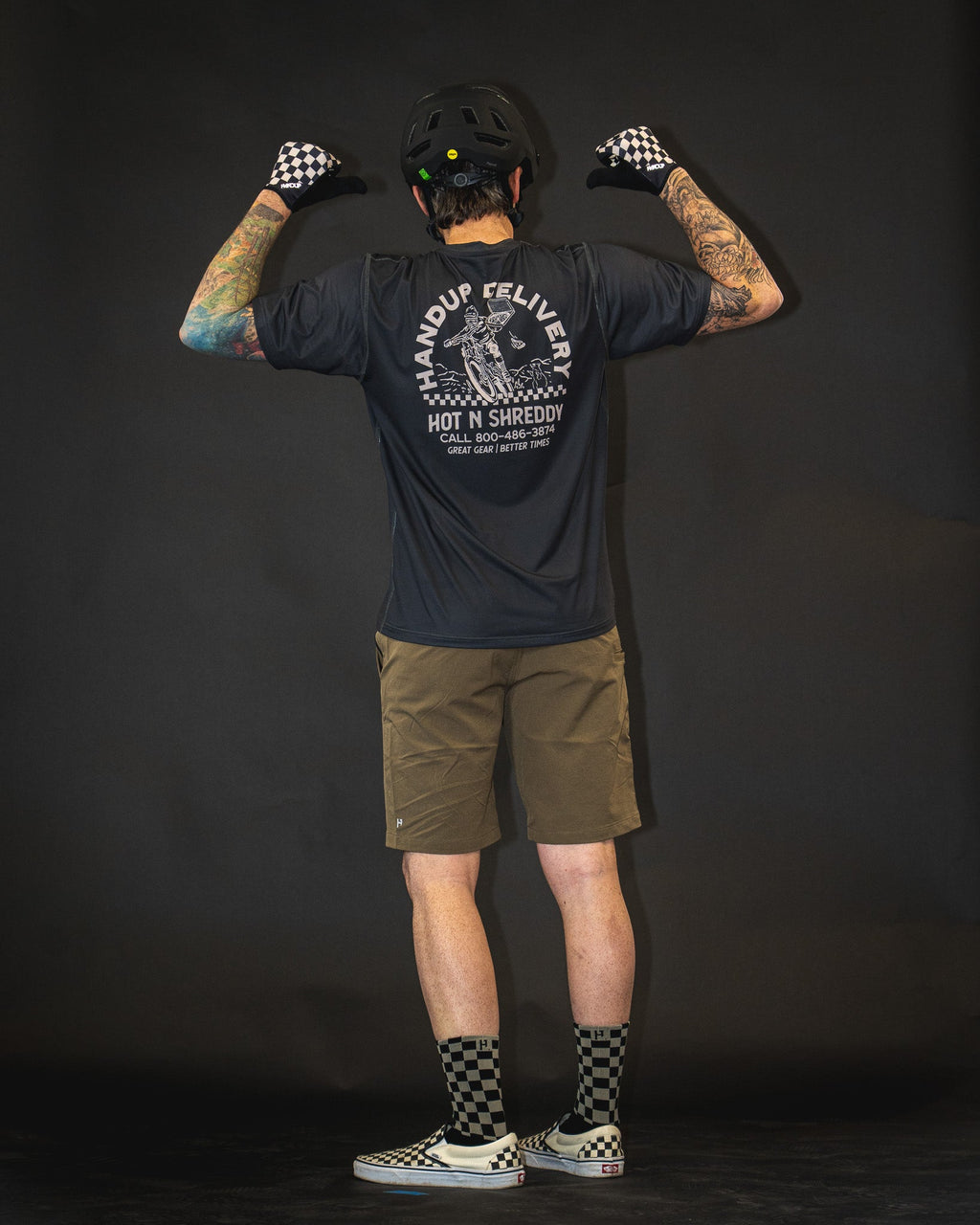 Handup Gloves, Checkered Black/Tan, worn by a rider, seen from behind