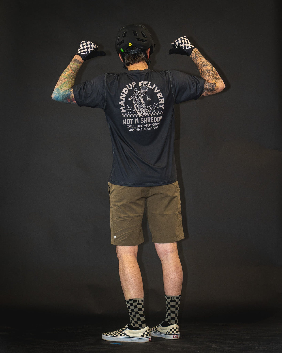 Handup Gloves, Checkered Black/Tan, worn by a rider, seen from behind