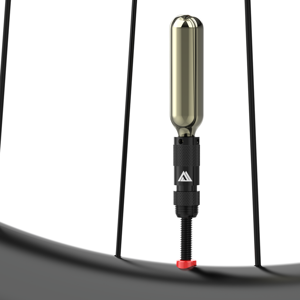 KOM Tire Repair Tool PRO, tool with CO2 cartridge on a tubeless valve