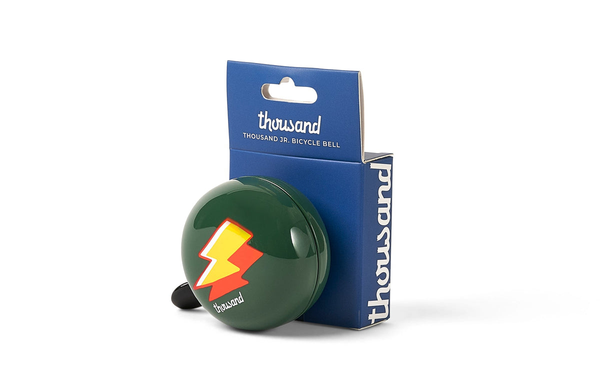 Thousand Jr. Bicycle Bell, green with lightning bolt print, in packaging
