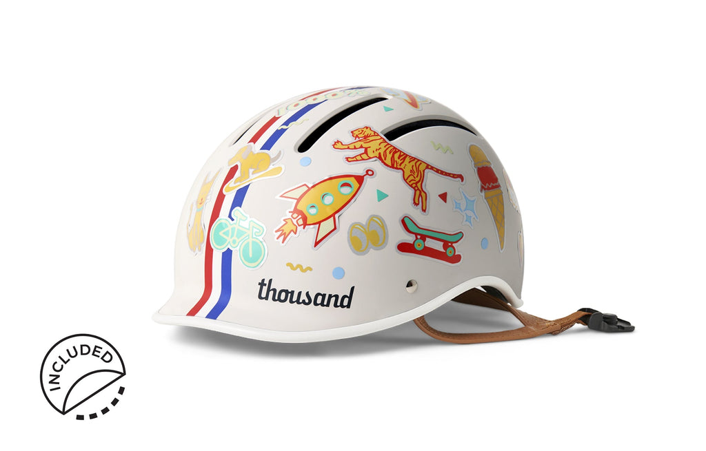 Thousand Jr. Kids Helmet, white with red and blue stripes, decorated with stickers