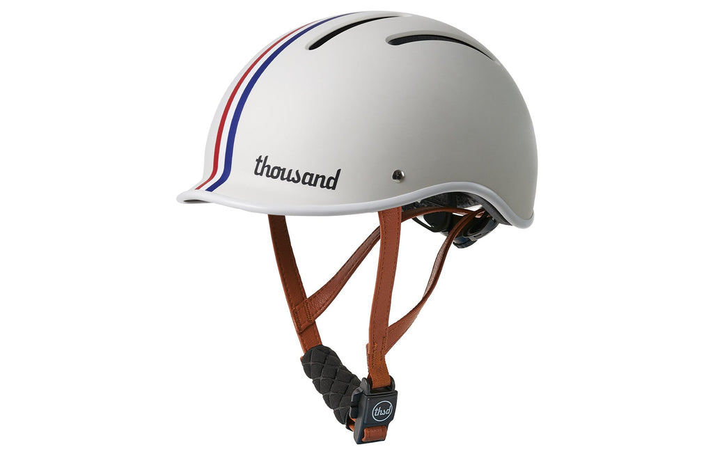 Thousand Jr. Kids Helmet, white with red and blue stripes, side view with straps