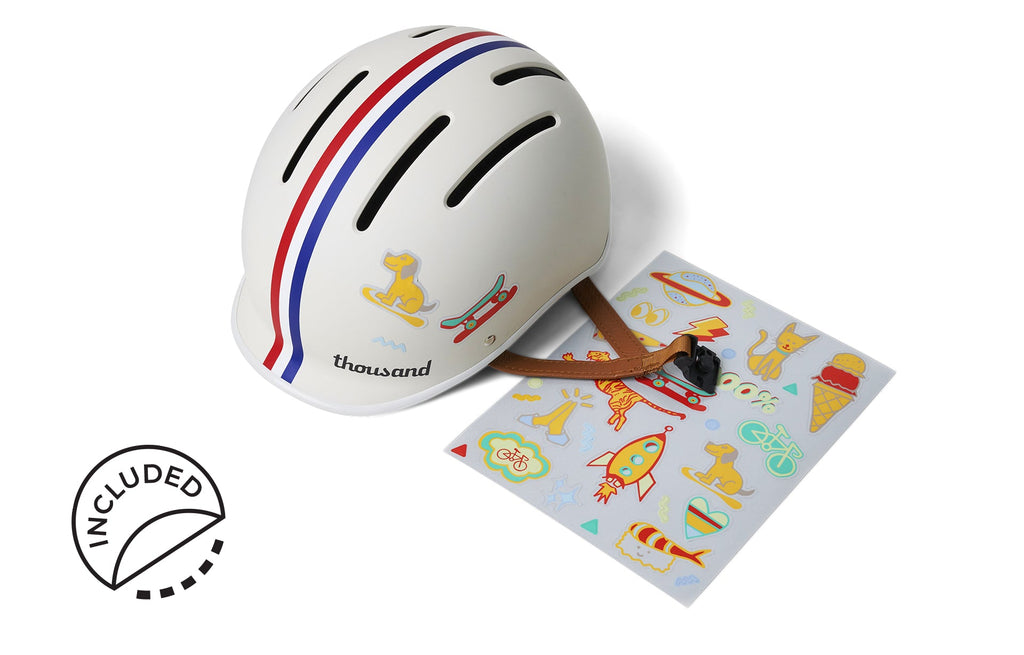 Thousand Jr. Kids Helmet, white with red and blue stripes, with included sticker sheet
