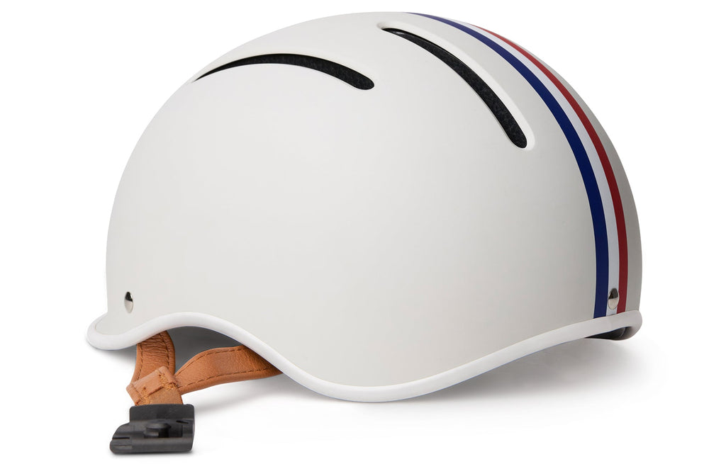 Thousand Jr. Kids Helmet, white with red and blue stripes, close-up side view