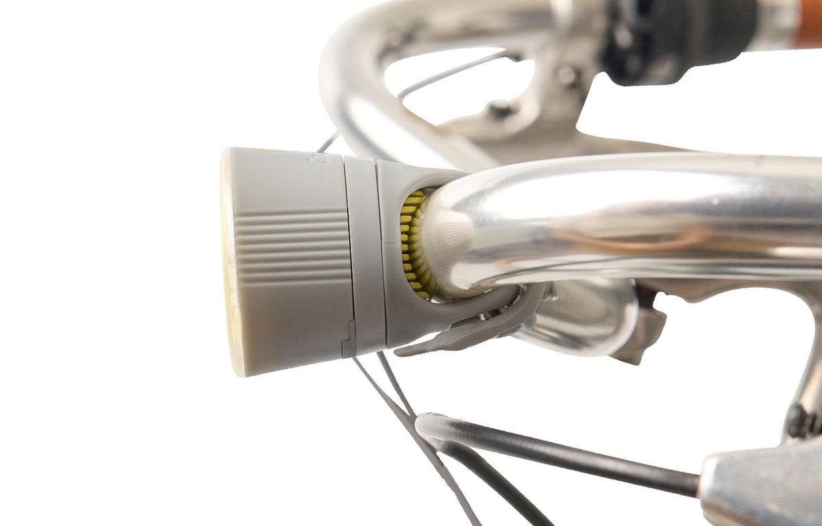Traveler 2.0 Magnetic Bike Lights, gray front light mounted on a handlebar