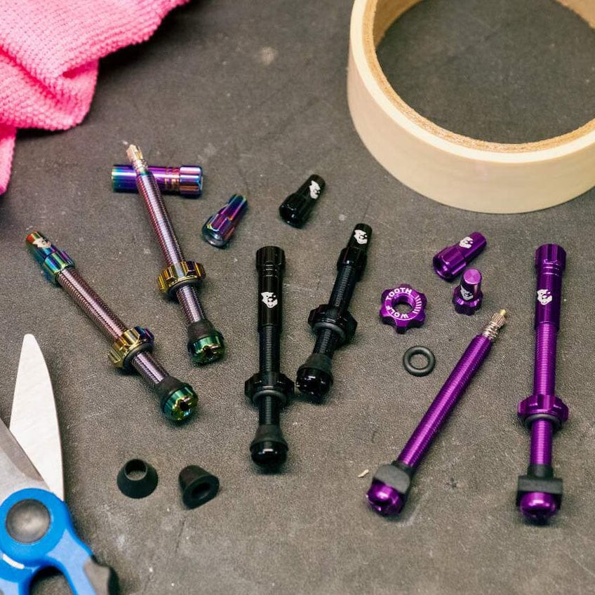 Wolf Tooth Tubeless Presta Valve Stem Kit, assorted colors and parts on a workbench