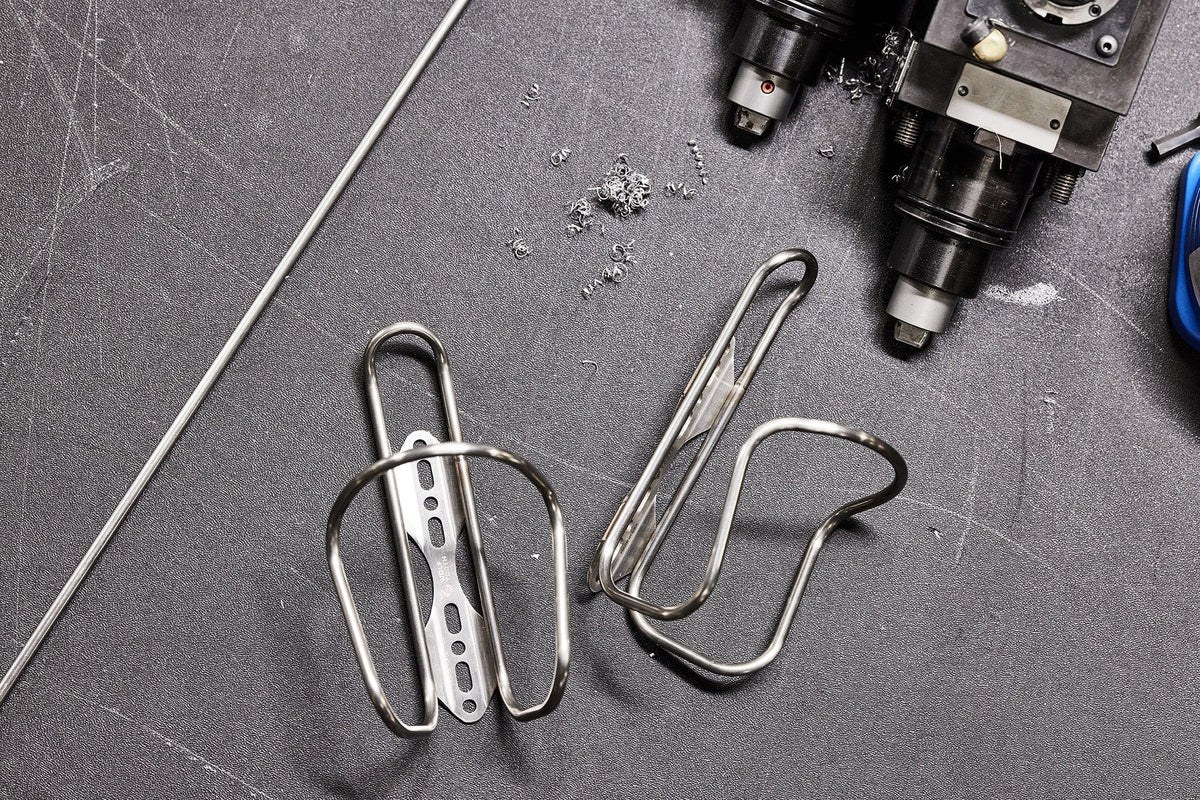 Wolf Tooth Morse Cage, Stainless Steel, two cages on a workbench