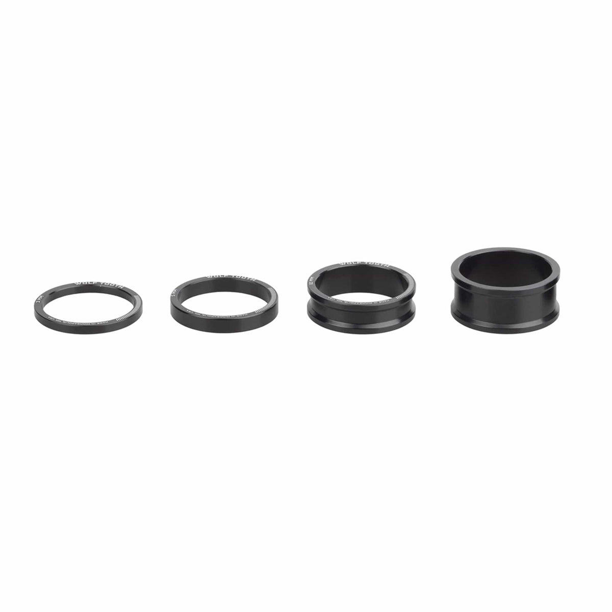 Wolf Tooth precision headset spacers in black, four heights from thin to tall