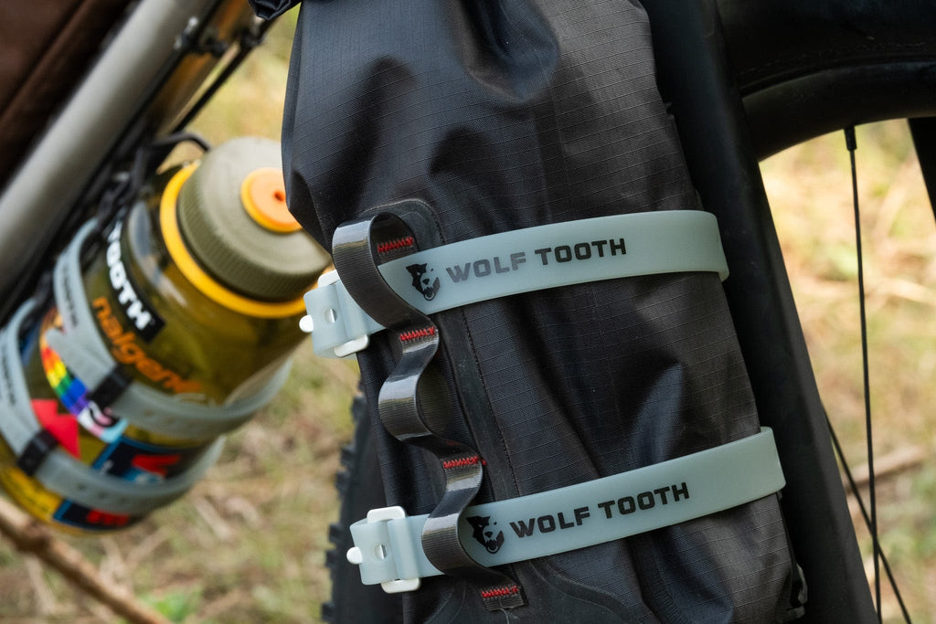 Wolf Tooth Morse Cargo Cage, holding a dry bag and bottle with straps