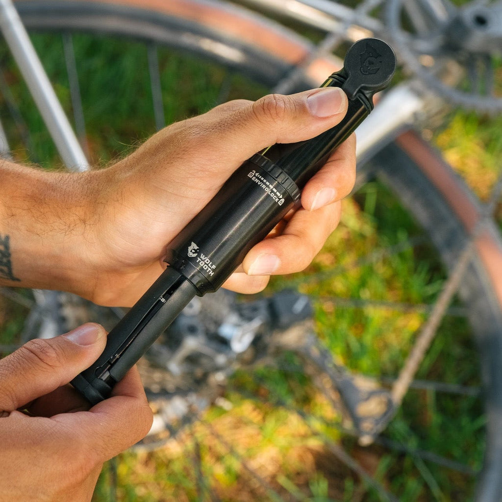 Wolf Tooth EnCase Pump 40cc, pump being opened beside a bike